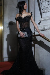 Side view of the black off-the-shoulder gown with scalloped floral shoulder detail
