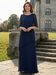 Dark navy chiffon A-line mother of the bride dress with a scoop neck, flutter sleeves and tiered ruffles, shown full length.