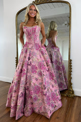 Fuchsia floral jacquard strapless ball gown prom dress with pearl-edged corset bodice