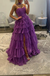 Purple glitter tulle ball gown prom dress with ruched sweetheart bodice, tiered ruffles and high slit, front view