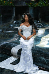Off-the-shoulder beaded mermaid prom dress in silver with feather hip accent, front view