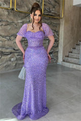 Front view of the purple sequin prom dress with short off-the-shoulder sleeves and sweep train
