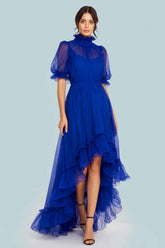 Royal blue tulle high-low prom dress with ruffled high neck and sheer puff sleeves, full front view
