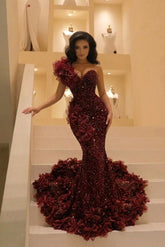 Burgundy sequin mermaid prom dress with ruffled one shoulder and 3D flower court train, front view