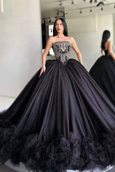Black strapless ball gown with lace applique bodice and ruffled tulle skirt, front view