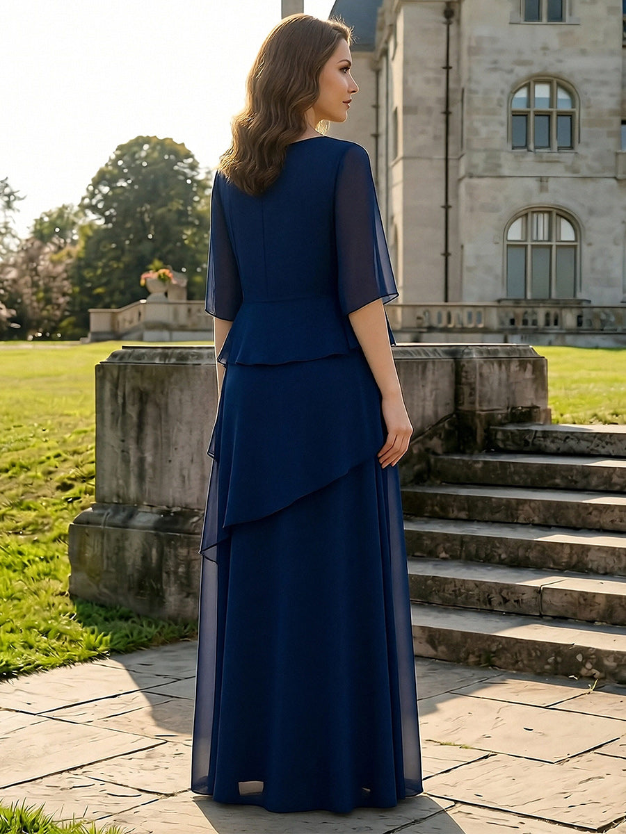 Back view of the dark navy chiffon mother of the bride dress with flutter sleeves, tiered ruffle skirt and zipper back.