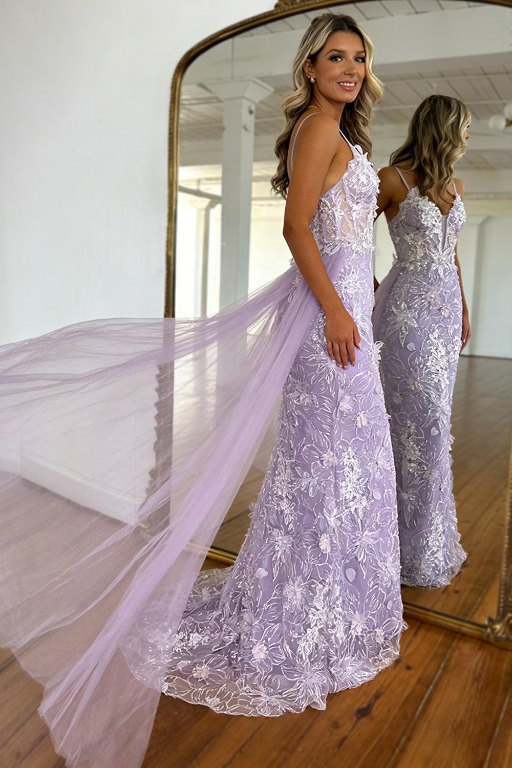 Sheer tulle cape flowing behind a lavender mermaid prom dress in side view