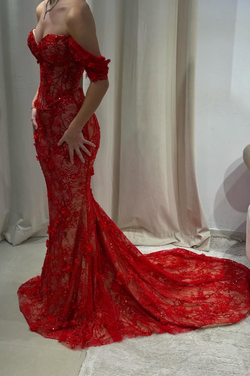 Side view of red off-the-shoulder mermaid prom dress with sweep train and 3D floral details