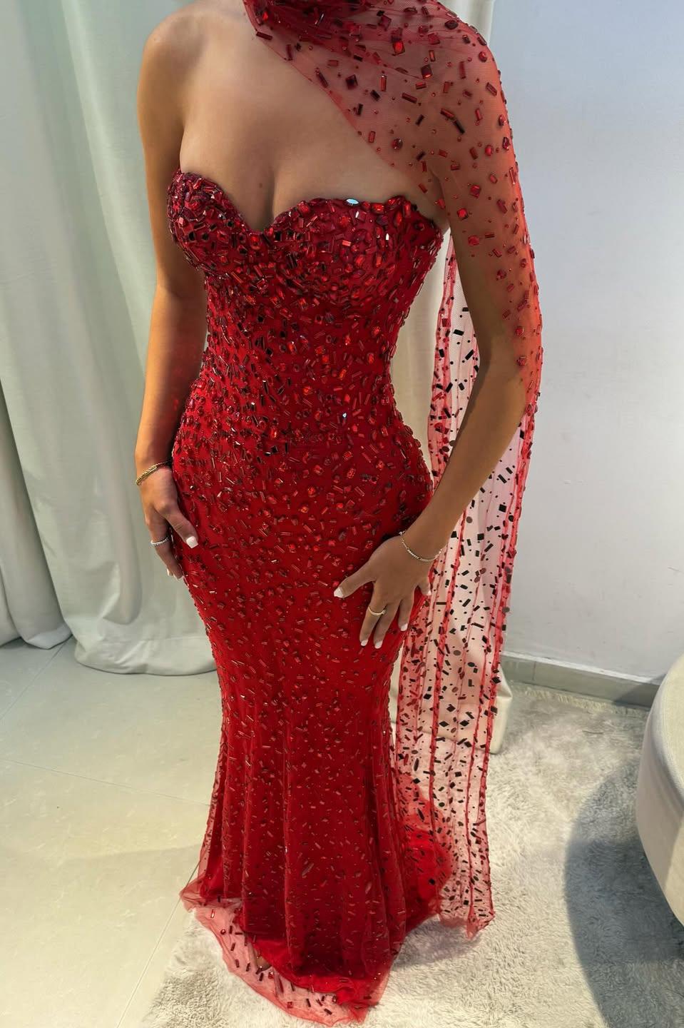 Close-up of red bead and sequin detailing on the fitted mermaid bodice