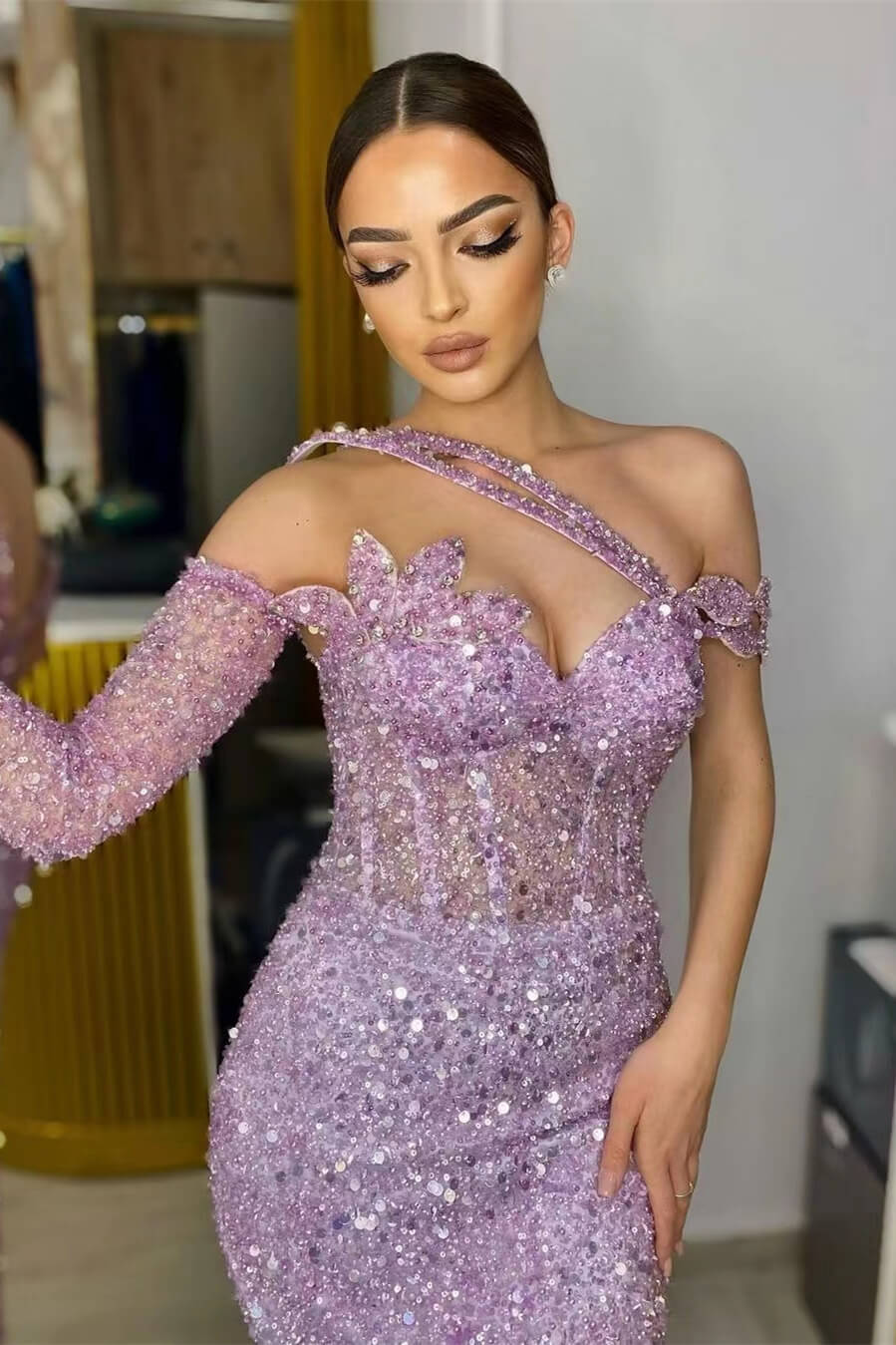 Close-up of lavender sequin prom dress showing 3D floral applique and one-shoulder strap