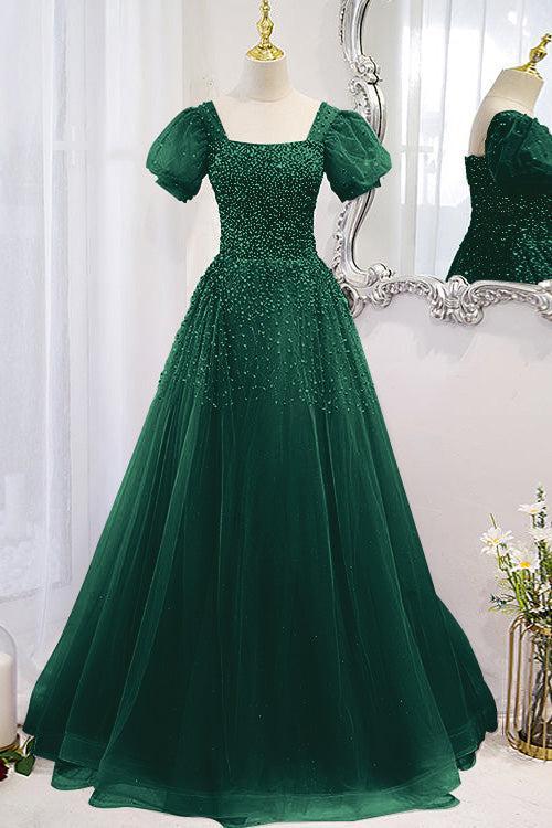 Dark green sequin-beaded A-line prom dress with square neck and puff sleeves on a dress form